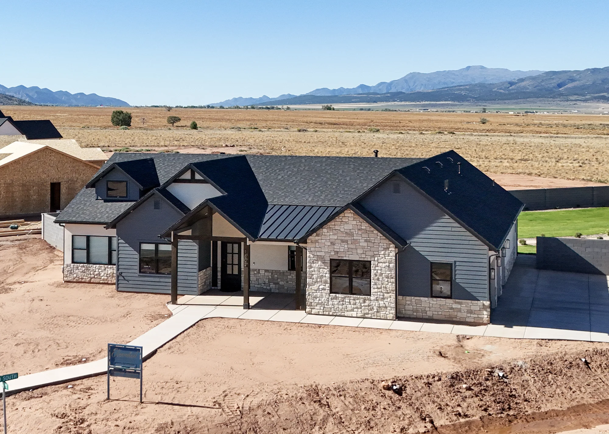 The Graham, a single-level custom home by Elevated Construction, with the valley and mountains behind it